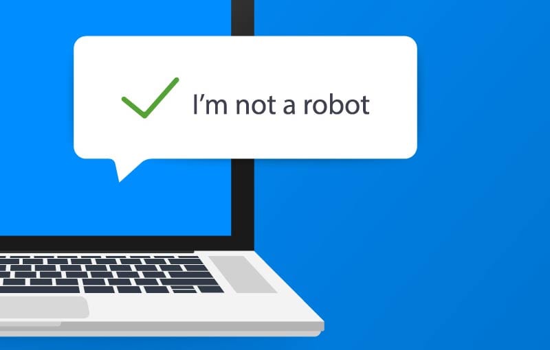 A graphic illustration of a cropped view of a laptop, with a speech bubble showing a green checkmark and the words 'I'm not a robot'