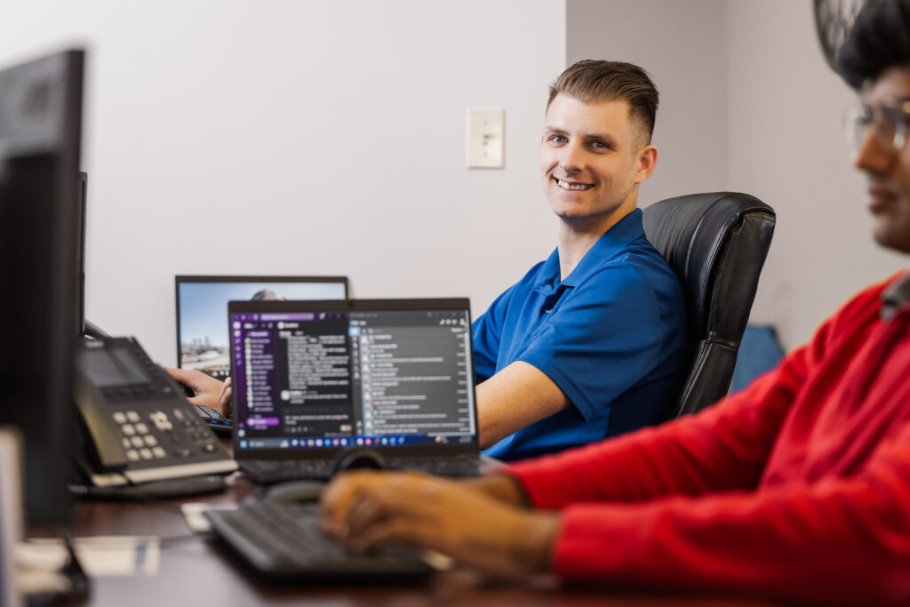 Saltech employees working on computers