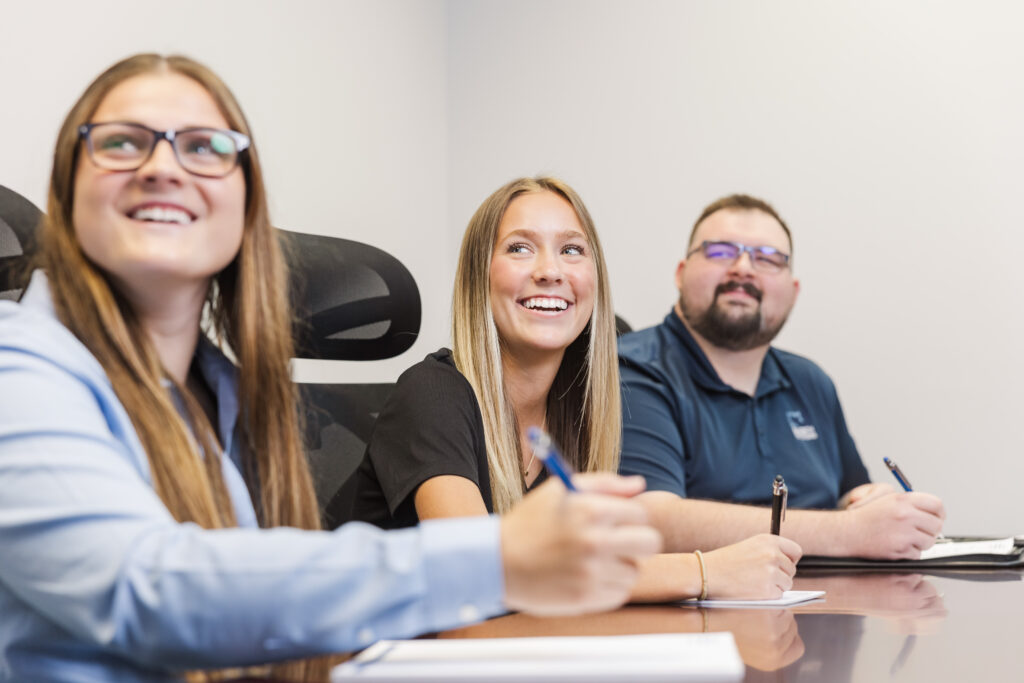 Saltech employees at the conference table taking notes