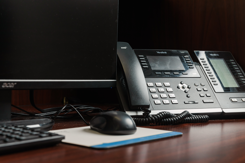 Closeup of mouse and phone on a Saltech employee's desk