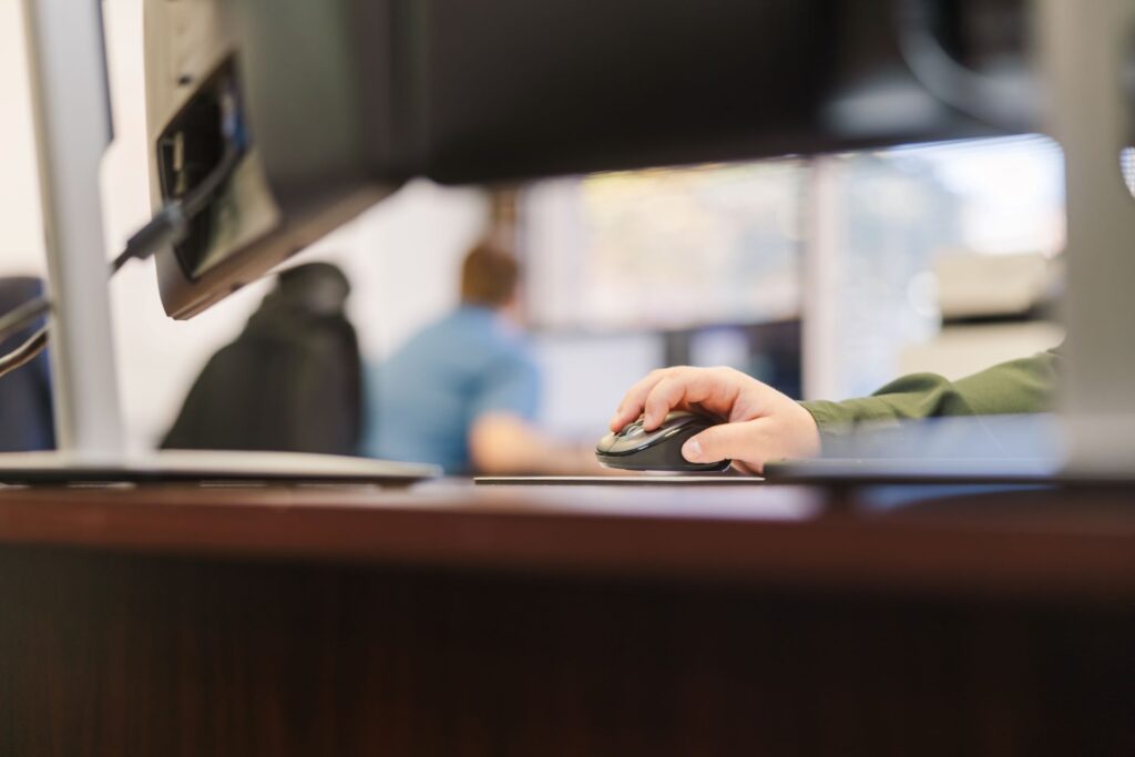 Closeup of an employee's hand using her mouse