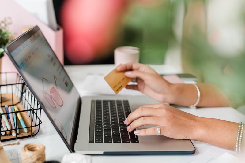 Person shopping online and holding a credit card