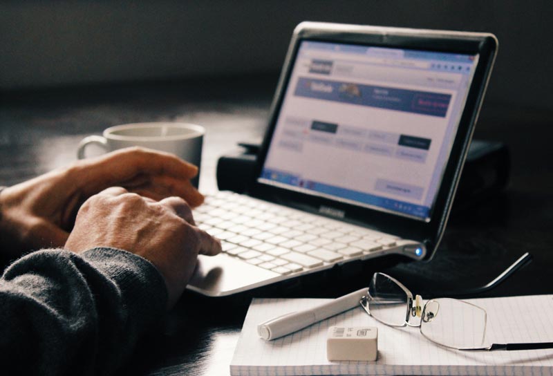 PErson typing on a laptop