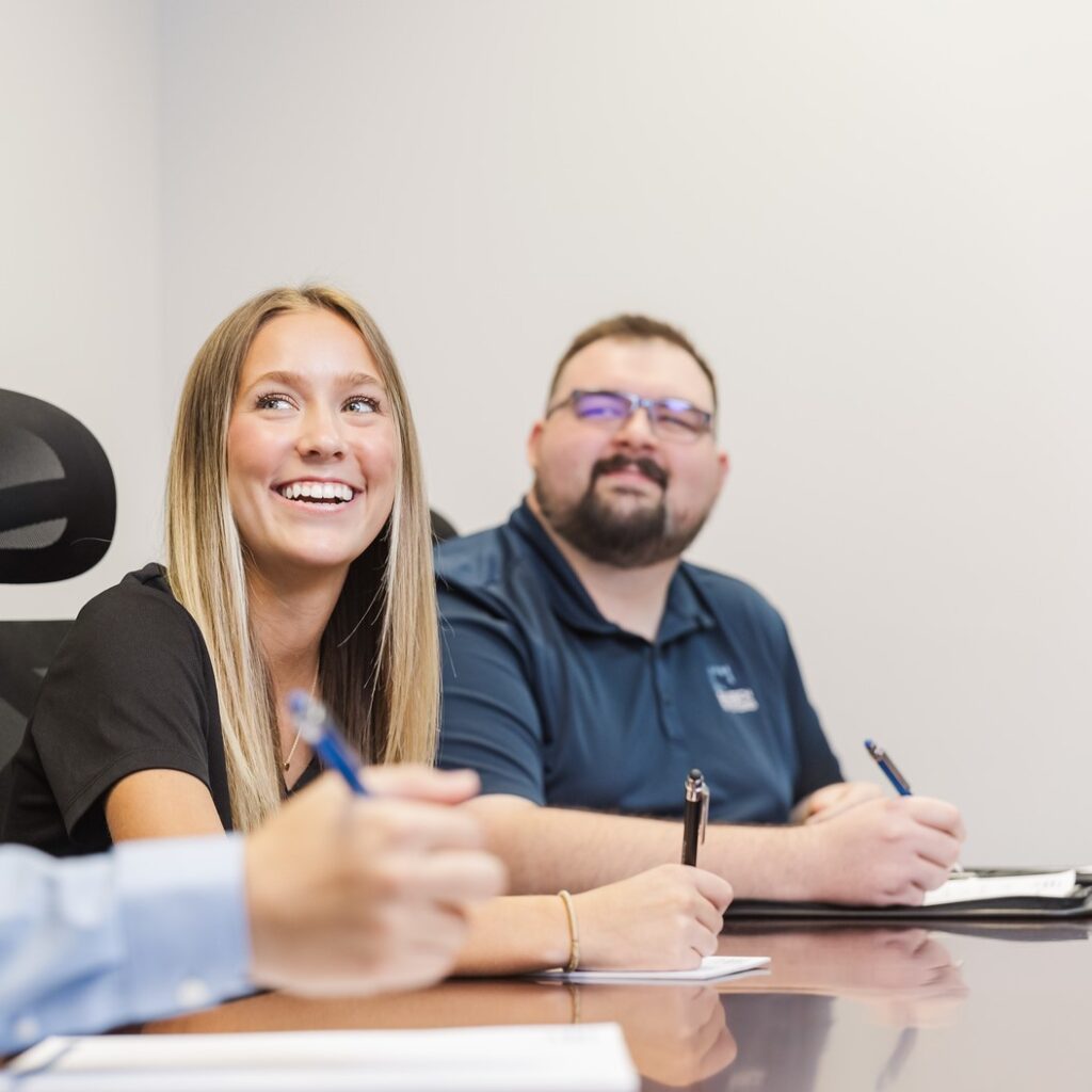 Saltech employees taking notes in the conference room