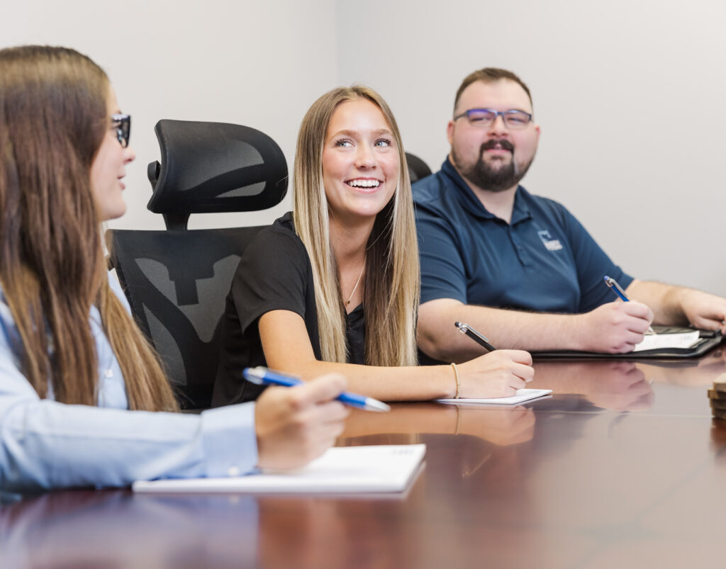 Saltech Employees sitting at the conference table taking notes