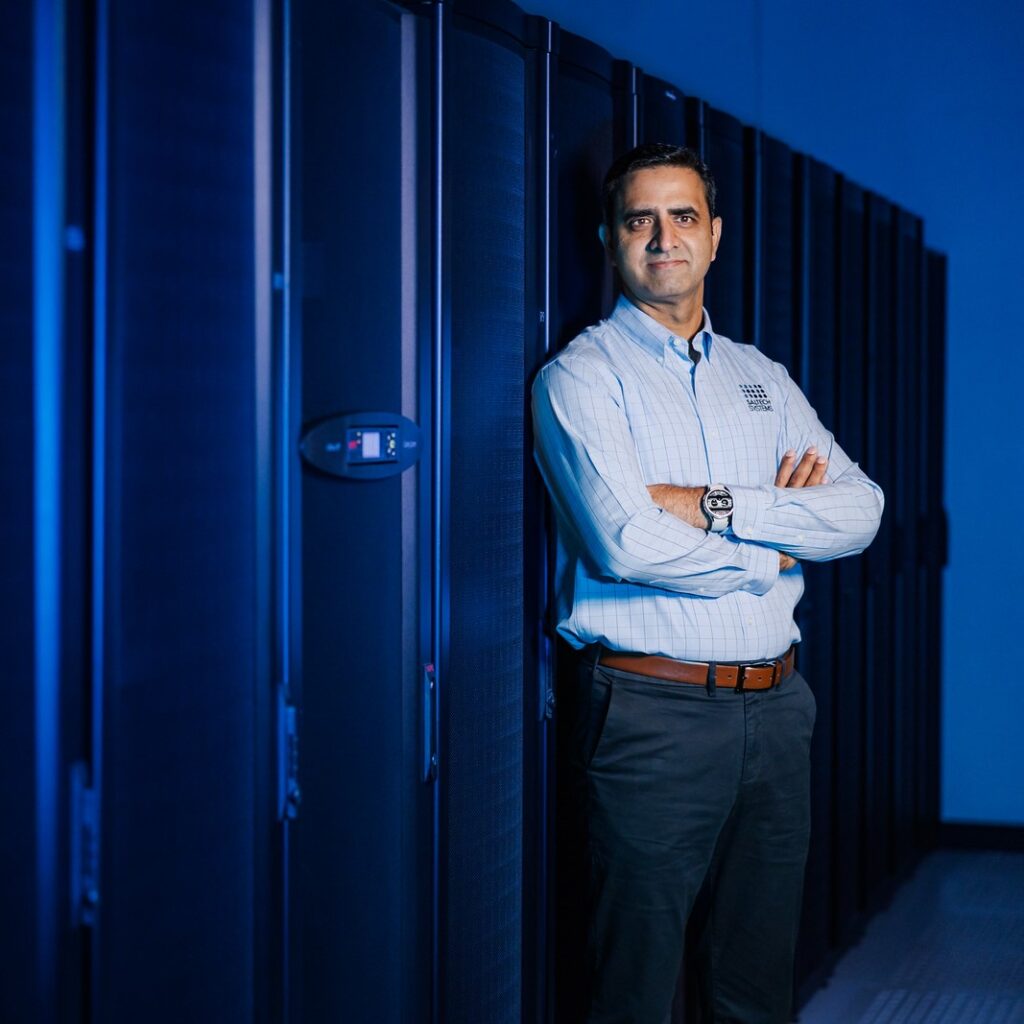 Salman Maqsood posing in the Saltech server room