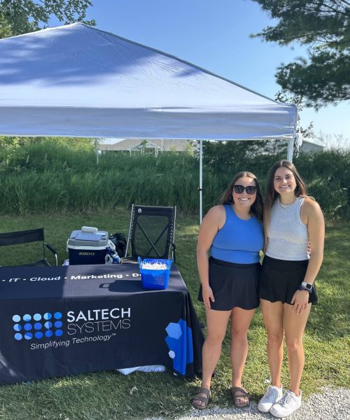 Saltech employees standing at a theme booth at a golf course