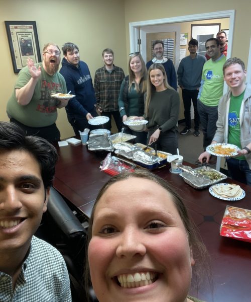 Saltech employees in the conference room for a potluck