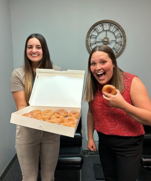 Saltech employees posing with donuts